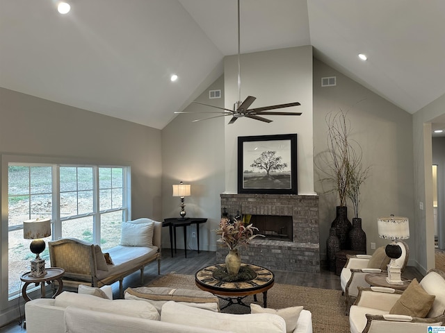 living room with ceiling fan, a fireplace, dark hardwood / wood-style flooring, and vaulted ceiling