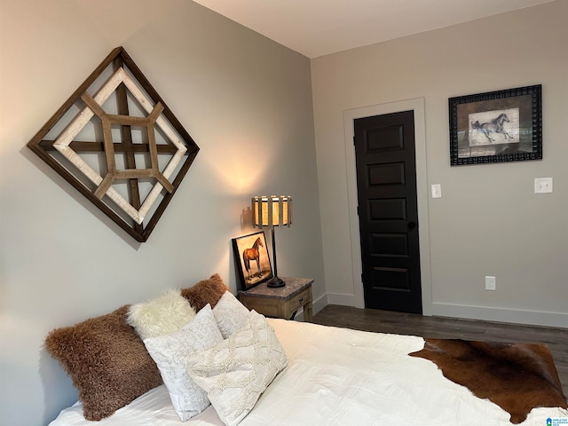 bedroom with dark hardwood / wood-style flooring