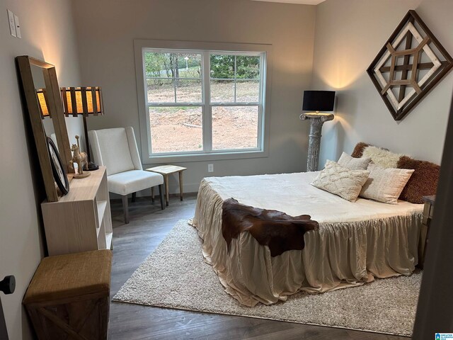 bedroom with dark hardwood / wood-style floors