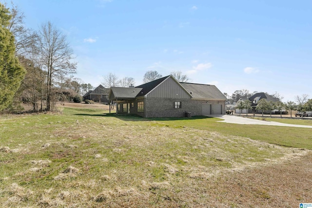 view of property exterior with a yard and a garage