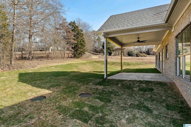 view of yard featuring a patio and ceiling fan