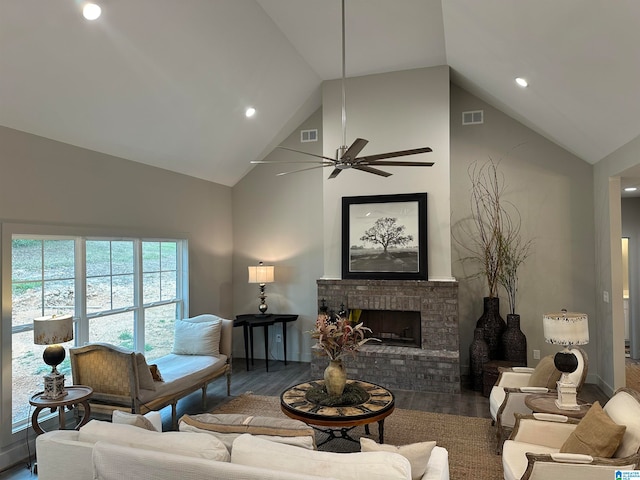 living room with a brick fireplace, vaulted ceiling, dark hardwood / wood-style floors, and ceiling fan