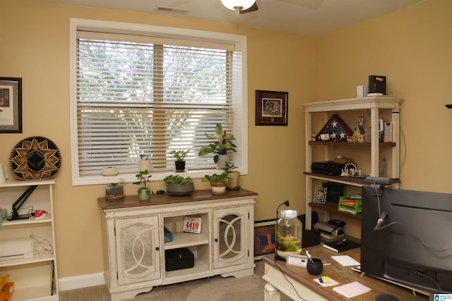 carpeted office with ceiling fan