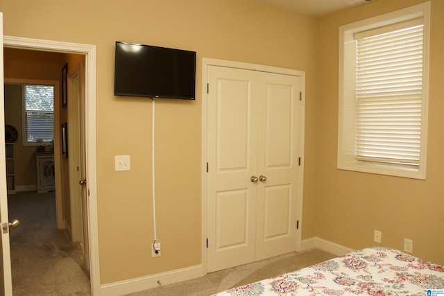 carpeted bedroom featuring a closet