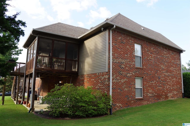 view of home's exterior with a lawn, a sunroom, and a deck