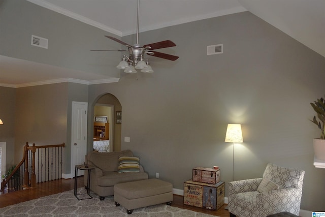 living room featuring ceiling fan, wood-type flooring, crown molding, and lofted ceiling