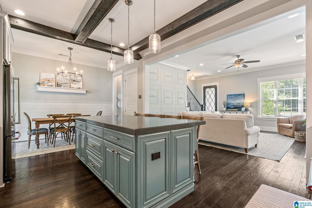 kitchen with dark wood-type flooring, hanging light fixtures, a center island, and beam ceiling