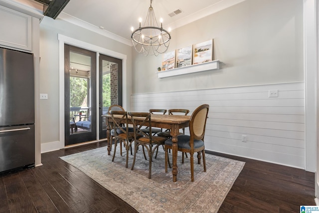 dining area with ornamental molding, dark hardwood / wood-style flooring, and a chandelier