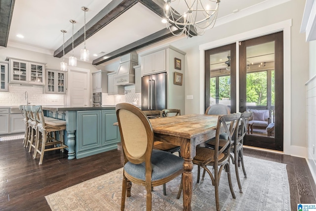 dining space with dark hardwood / wood-style flooring, a chandelier, beam ceiling, and crown molding