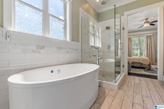 bathroom featuring ceiling fan, tile walls, hardwood / wood-style floors, and plus walk in shower