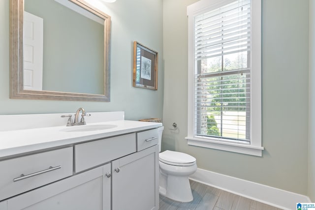 bathroom featuring vanity, toilet, and tile floors