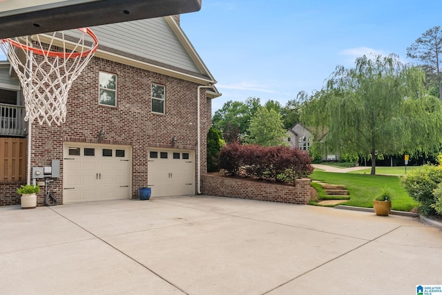 view of side of home featuring a garage and a yard