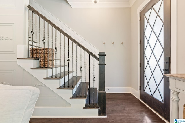 stairway with dark wood-type flooring and crown molding