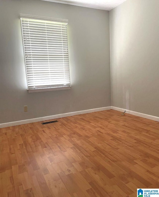 unfurnished room with light hardwood / wood-style floors