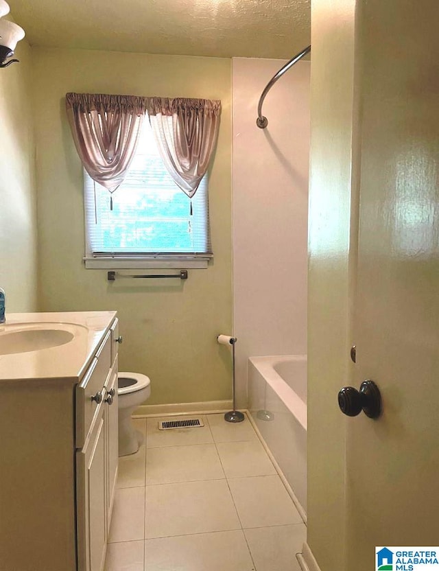 full bathroom with tile patterned flooring, a textured ceiling, toilet, vanity, and shower / bathtub combination