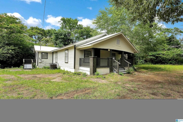 view of front of property with covered porch and central air condition unit