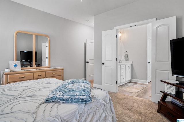 carpeted bedroom with ensuite bathroom