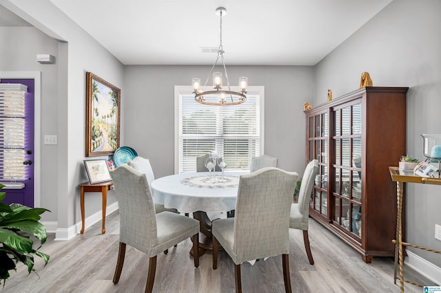 dining room with a chandelier and light hardwood / wood-style floors