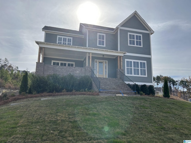 view of front of property featuring covered porch and a front lawn