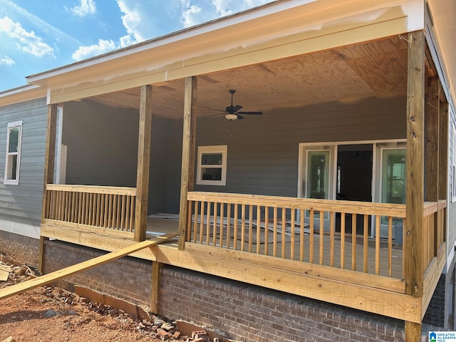 wooden deck featuring ceiling fan