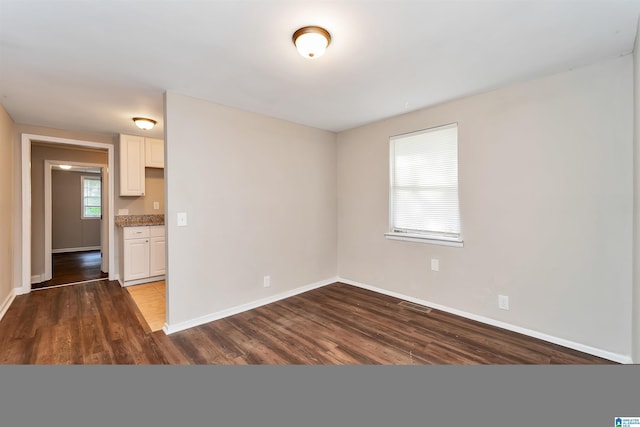 empty room with hardwood / wood-style flooring