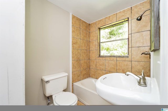 full bathroom featuring toilet, sink, and shower / washtub combination