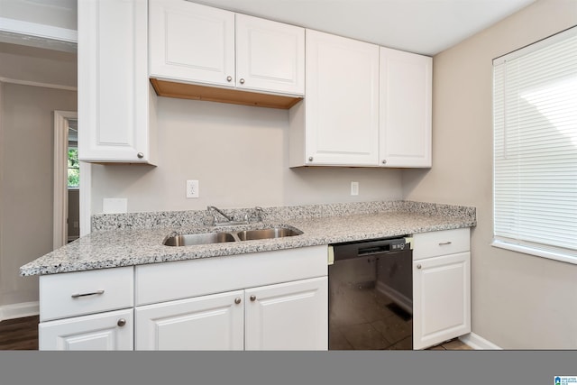 kitchen featuring dishwasher, light stone counters, white cabinetry, and sink