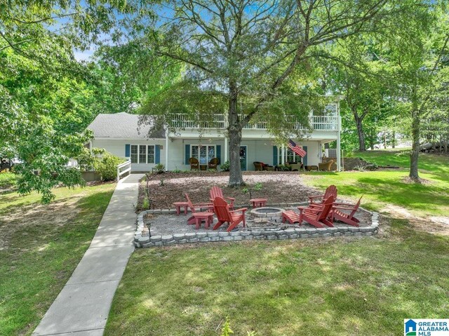 view of front of home featuring a front lawn, a fire pit, a patio area, and a wooden deck