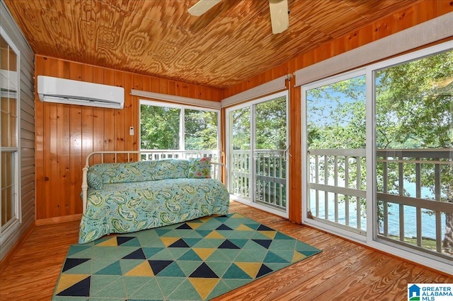 sunroom featuring a wall mounted AC, ceiling fan, and wooden ceiling