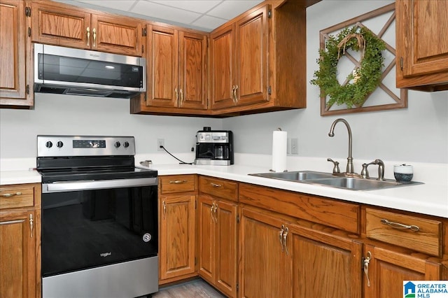 kitchen featuring sink, a paneled ceiling, and stainless steel appliances