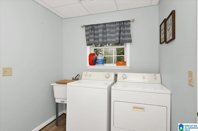 clothes washing area featuring washer and clothes dryer and hardwood / wood-style floors