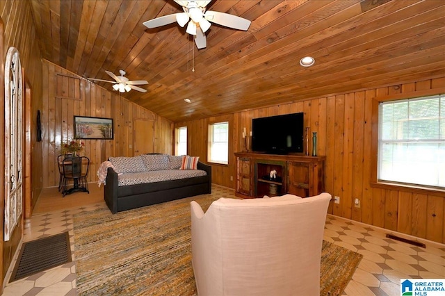 living room featuring vaulted ceiling, wood walls, ceiling fan, and wood ceiling