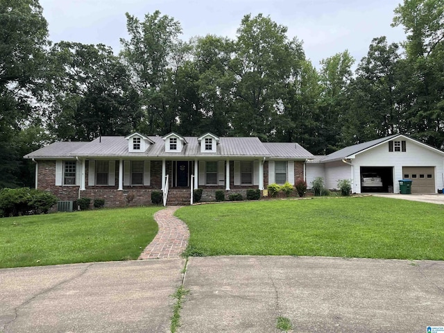 view of front of property featuring covered porch, a garage, and a front lawn