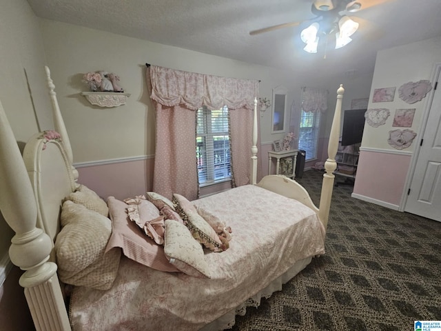 carpeted bedroom with ceiling fan and a textured ceiling