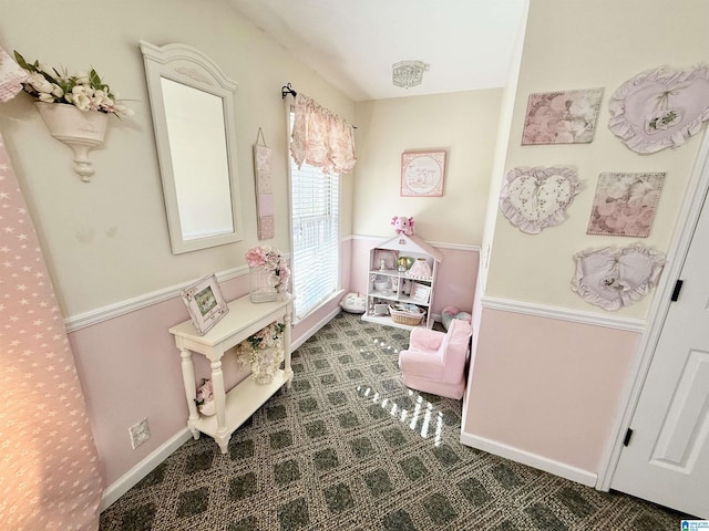 recreation room featuring dark colored carpet