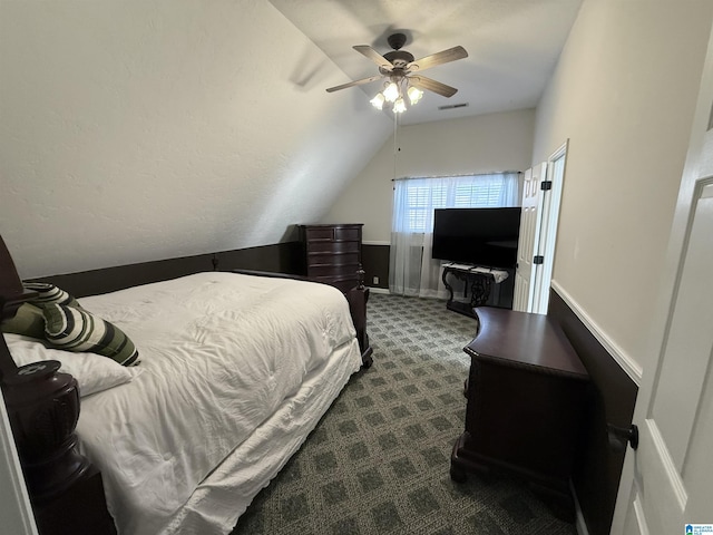 bedroom featuring vaulted ceiling, ceiling fan, and dark colored carpet