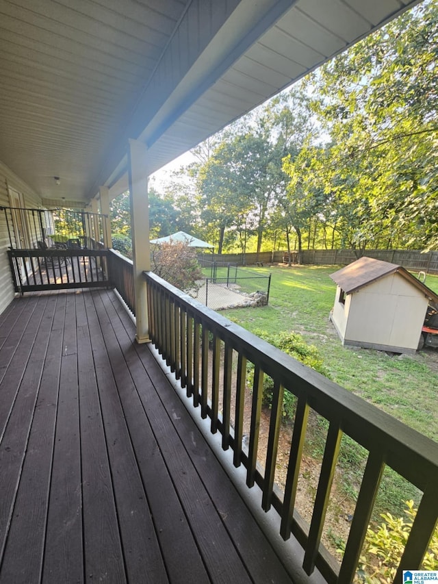 deck with a storage unit and a yard