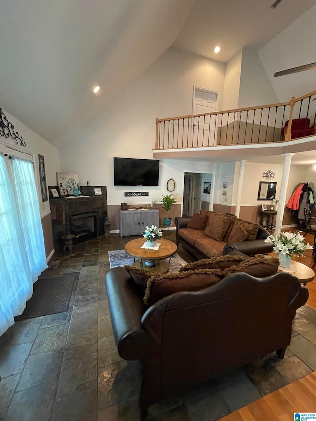 living room featuring high vaulted ceiling and dark wood-type flooring