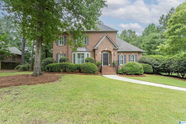 colonial inspired home with a front lawn