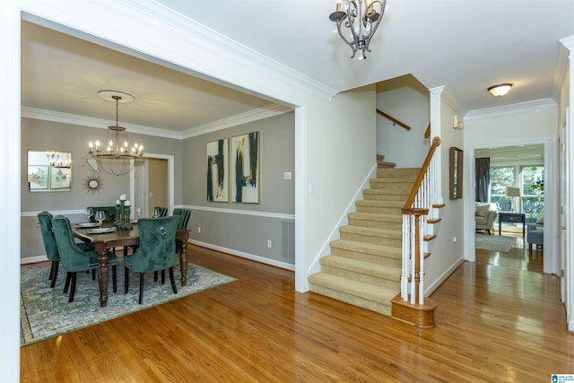 dining room featuring hardwood / wood-style flooring, a chandelier, and ornamental molding