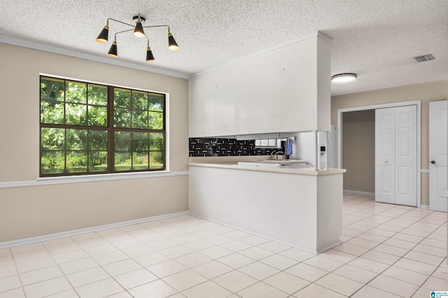 kitchen with sink, white fridge with ice dispenser, a textured ceiling, and light tile patterned floors