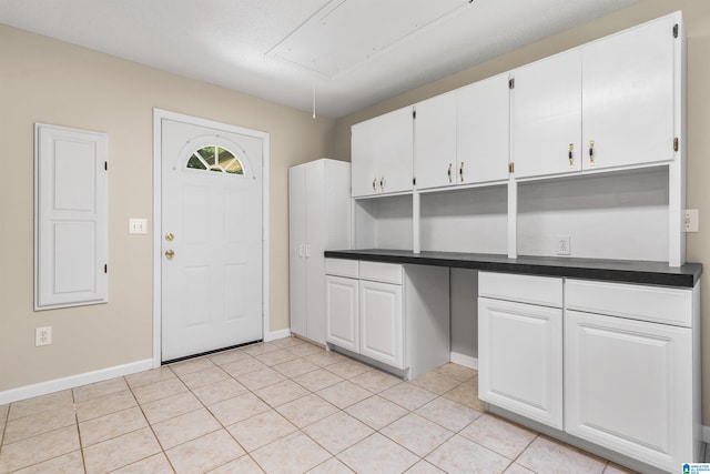 kitchen featuring white cabinetry and light tile patterned floors