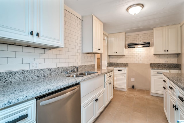 kitchen featuring decorative backsplash, sink, light tile patterned floors, and stainless steel dishwasher