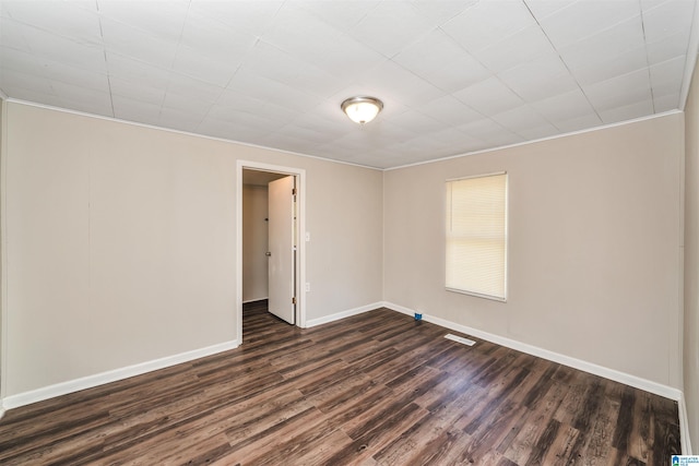 unfurnished room with dark wood-type flooring