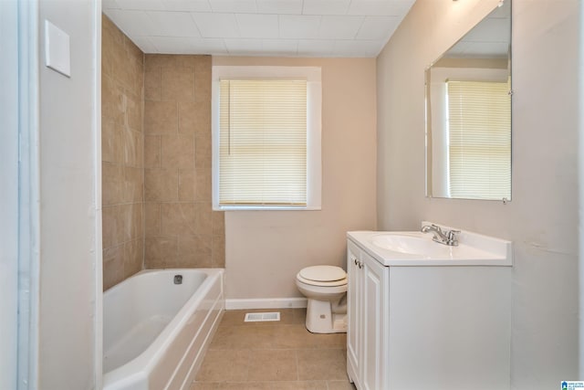 bathroom with a washtub, vanity, toilet, and tile patterned flooring