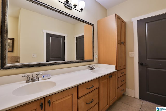 full bath with double vanity, a sink, and tile patterned floors