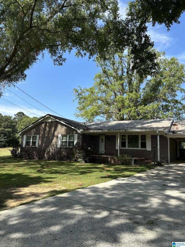 ranch-style home with a carport and a front yard