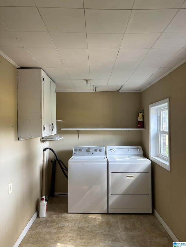 laundry room featuring washer and dryer and cabinets