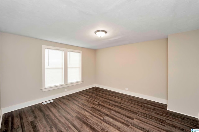 unfurnished room featuring dark hardwood / wood-style floors