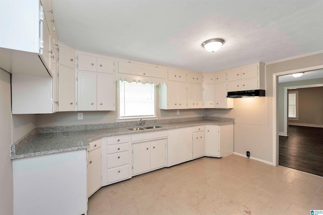 kitchen featuring white cabinets, plenty of natural light, and sink